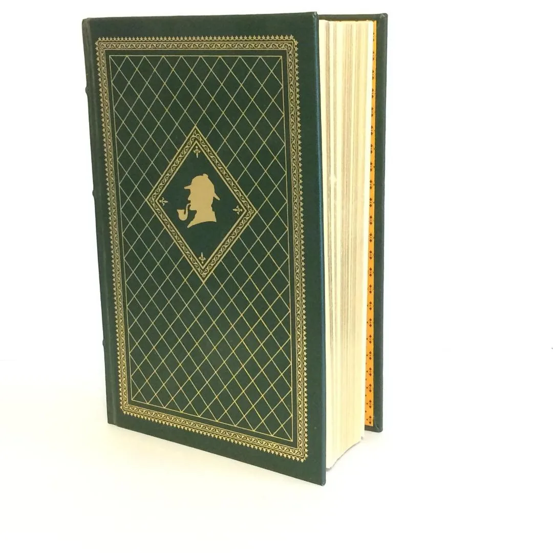 A green hardcover book with gold-coloured decorative detailing